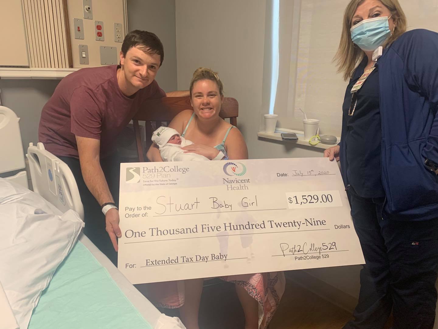 Family with newborn baby poses with Path2college donation check